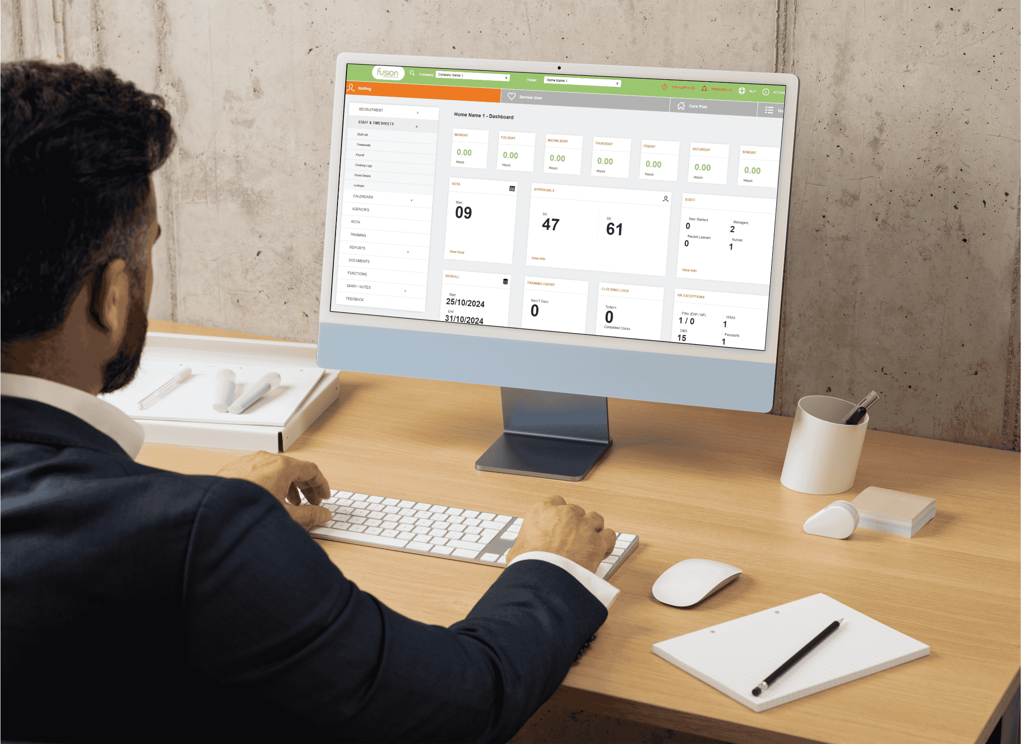 An image of a male office admin staff working on the Fusion's Staff management system